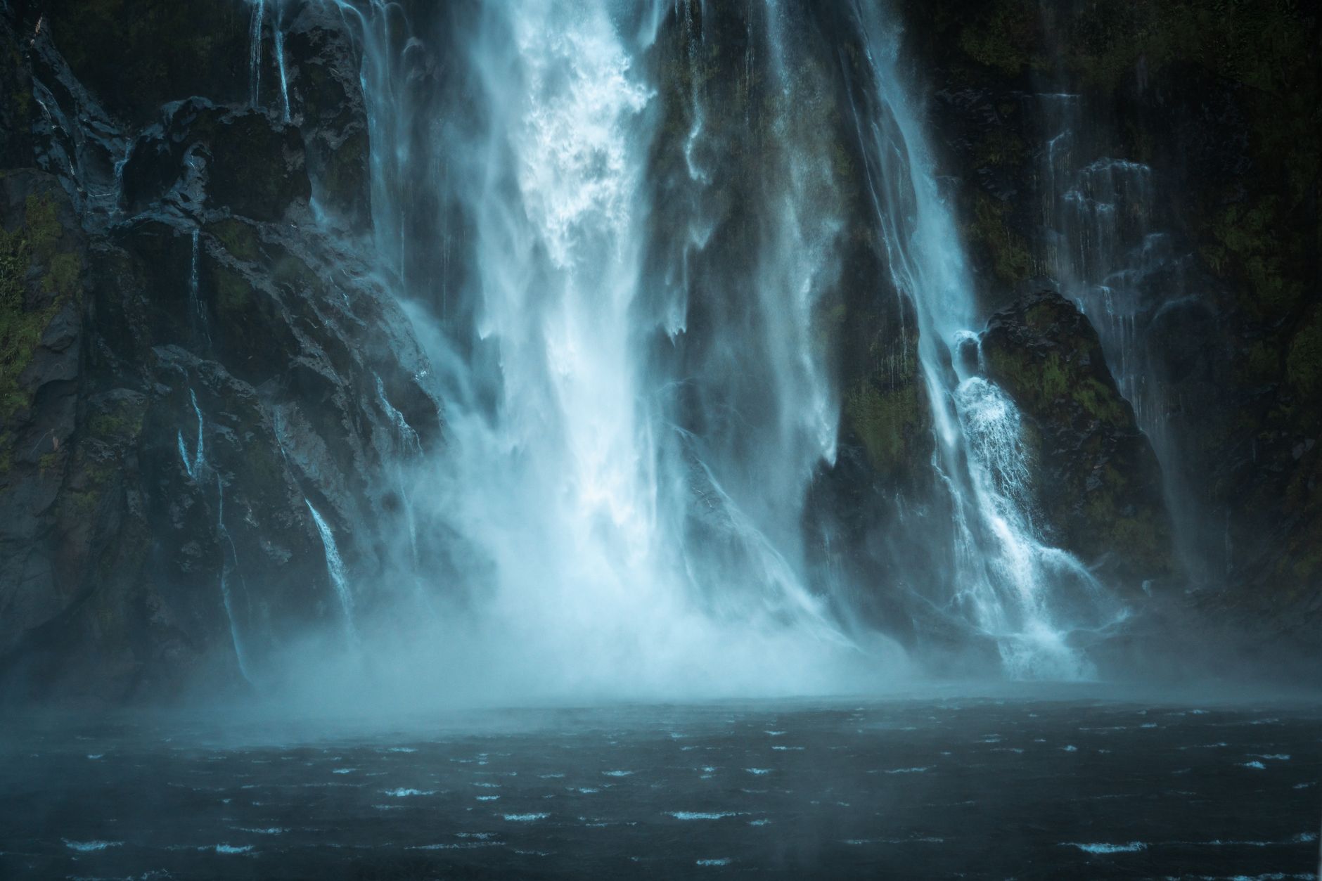 Dramatic rock cliffs and waterfalls in Milford Sound