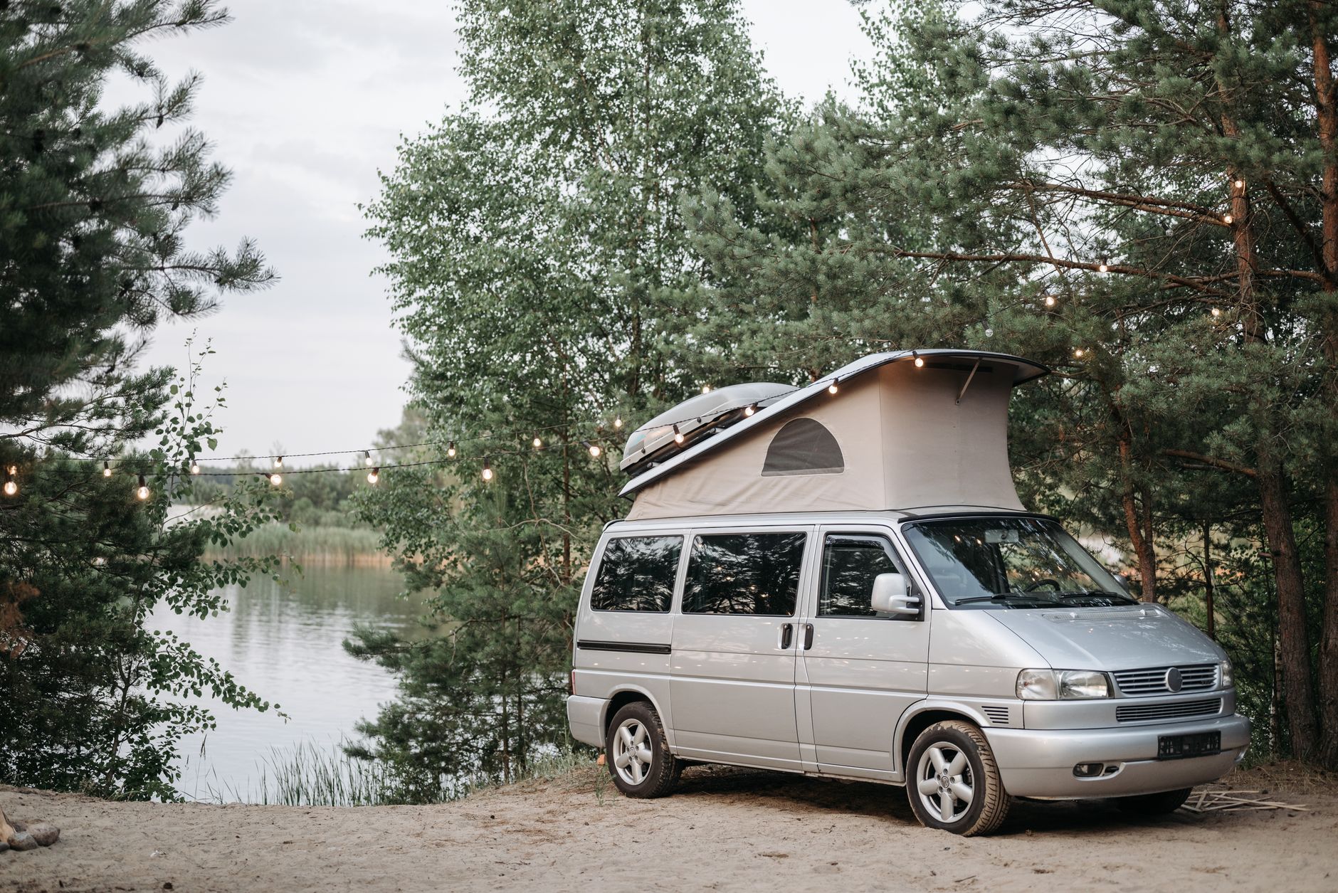 Campervan set up near mountain backdrop at sunset