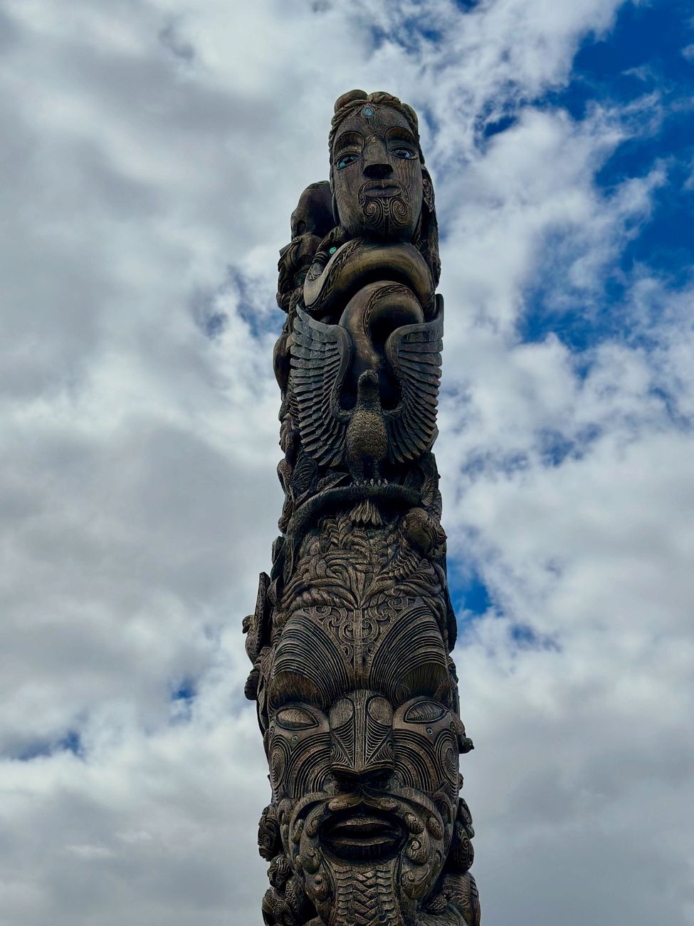 Intricate Maori wood carving on a traditional Wharenui structure